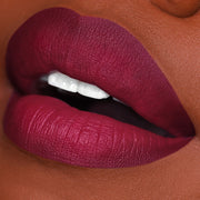 deep burgundy and purple liquid lipstick on black woman